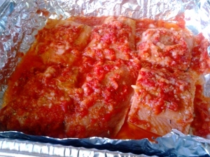 This is the uncooked salmon with the chopped sauce mix over it, ready to be baked!